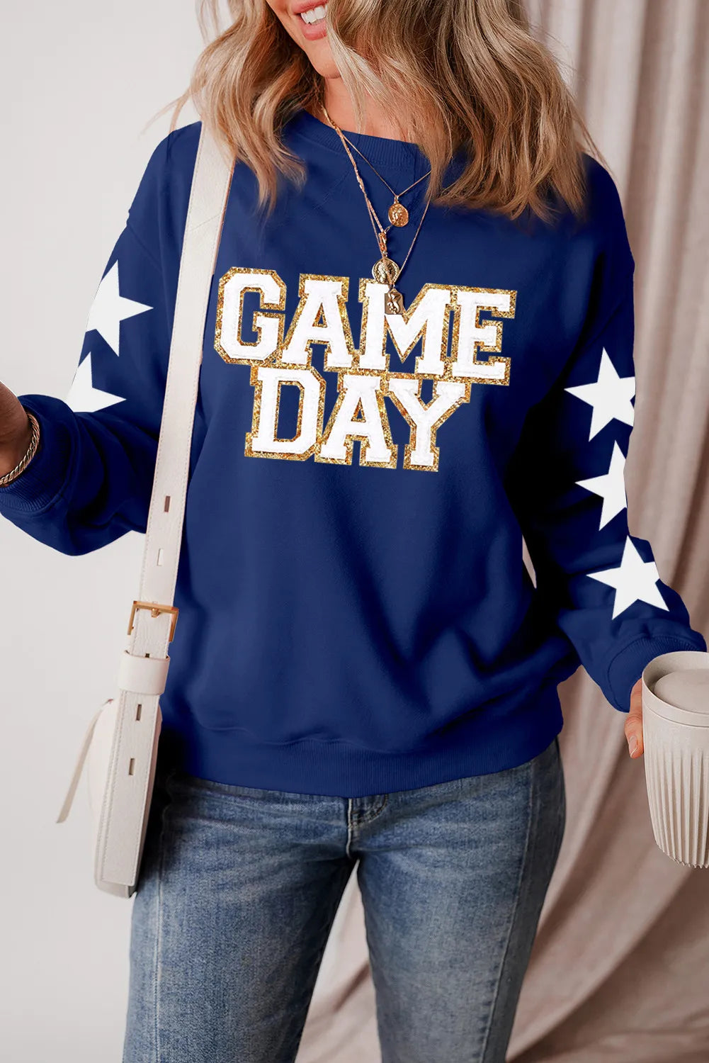 Enjoy optimal comfort and style on game day with the women's GAME DAY Star Sweatshirt. Crafted for fans seeking warmth alongside a streamlined appearance, it offers a soft fabric blend that ensures coziness throughout the event. The distinctive star motif provides a standout accent, making it an excellent option to showcase your team spirit with sophistication. Combining durability with easy maintenance, this sweatshirt perfectly balances practicality and style.
