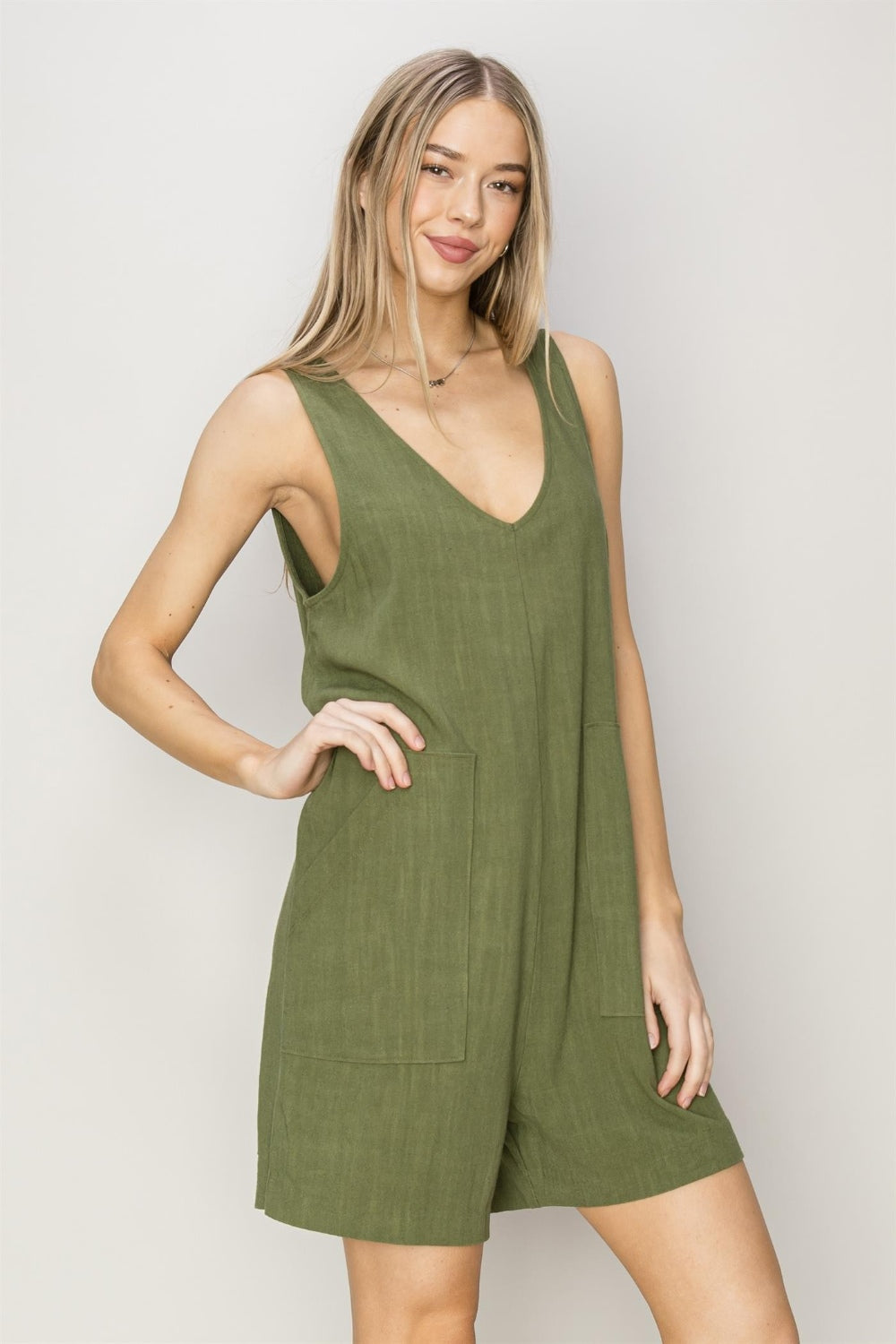 Stay stylish and comfortable in this V-Neck Sleeveless Romper made from a breathable 80% rayon and 20% linen blend. Its deep V-neck and relaxed bodice offer a flattering fit, while the breezy shorts keep you cool. Equipped with practical pockets, this romper combines function and fashion seamlessly. Pair it with sandals and a crossbody bag for an effortlessly chic, timeless look perfect for any casual outing.