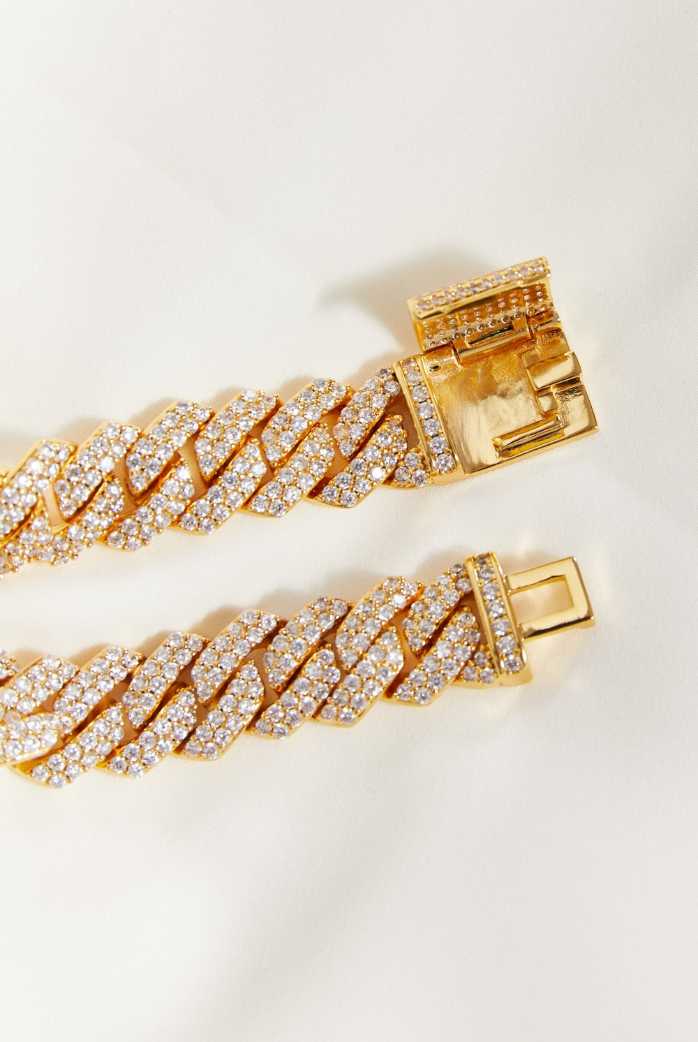Gold bracelet with diamond accents on a light background