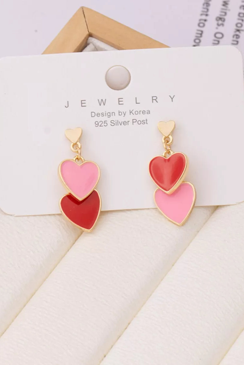 Heart-shaped earrings on a jewelry card with a white background