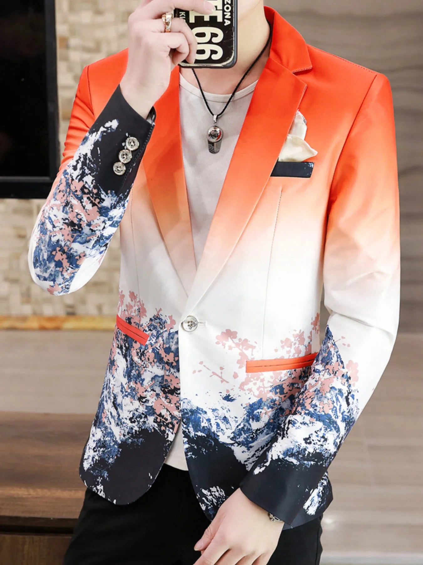 This men's blazer has a single button and long sleeves with a bright iridescent multi-color print. It offers a comfortable, flattering fit and adds a stylish touch for any occasion.