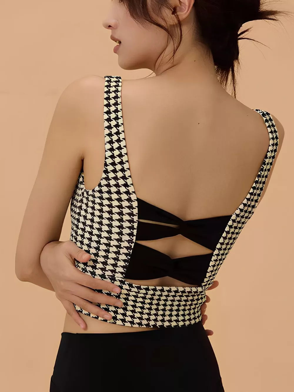 The Crisscross Back Houndstooth Active Top is expertly crafted to combine functionality with style. Designed to be worn as a supportive bra beneath button-up shirts, its elegant houndstooth pattern and distinctive crisscross back detail offer a polished look suitable for fashion, spa-inspired ensembles, or casual wear. This top provides comfortable support and enhances your outfit with a modern, sophisticated edge.
