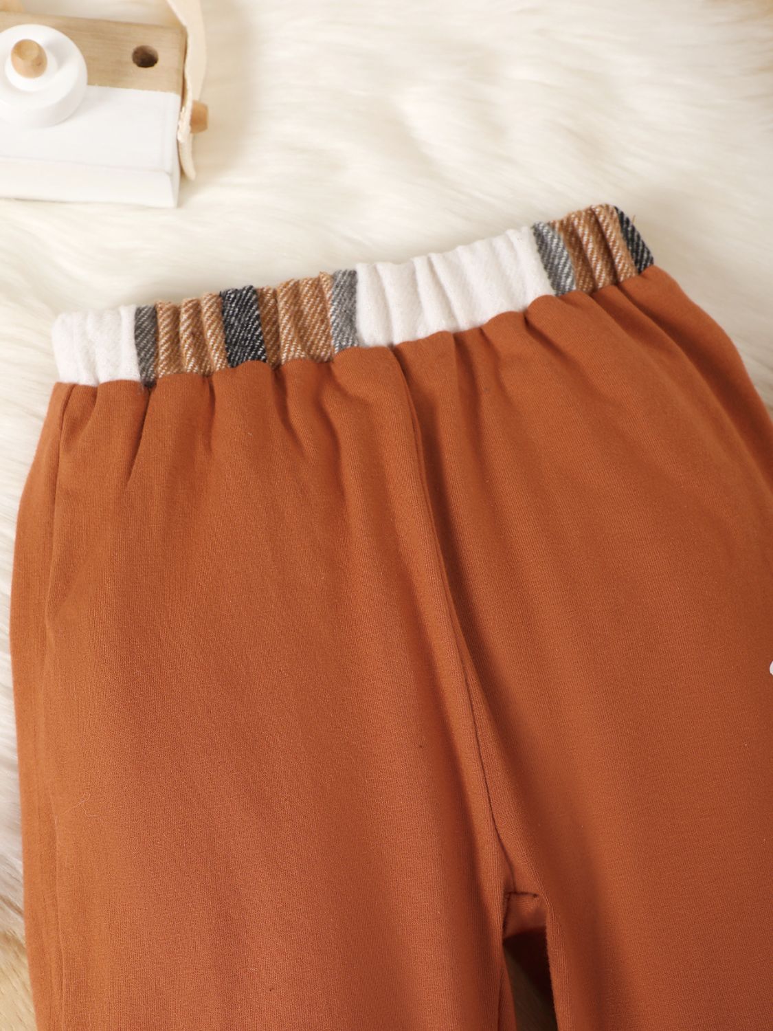 Upgrade your little one's wardrobe with Momma's Boy top and pants set. The stylish color block design and easy-to-use button up closure make it perfect for any event. Plus, the machine washable fabric makes it a practical choice for busy moms. Elevate their style while keeping things low maintenance!