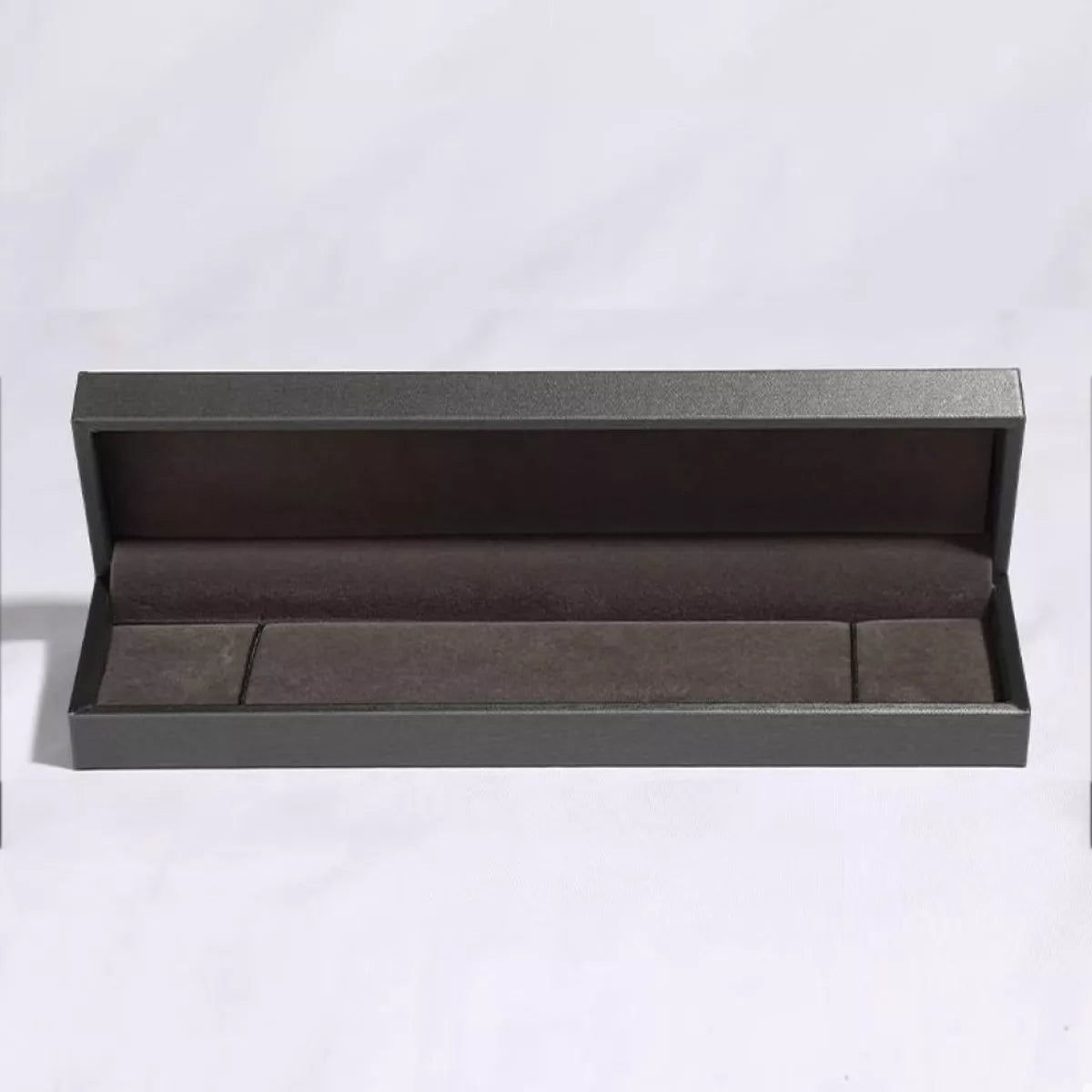 Open gray jewelry box on a white background