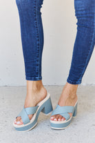 Effortlessly blending style and comfort, these Misty Blue platform sandals feature adjustable crisscross straps that provide a secure fit for any foot shape. The striking contrasting colors offer a contemporary, standout look. With a platform sole that adds both height and stability, these sandals are ideal for all-day wear. Enhance your summer wardrobe with these fashionable and comfortable shoes.