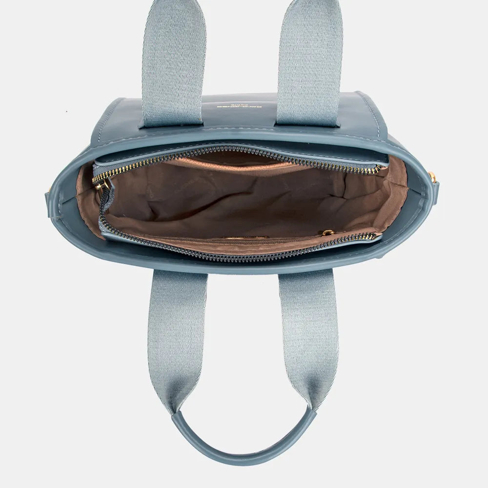 The Small Handbag with Embossed Pattern Handles features a compact, structured design with detailed embossed handles for a refined look. It fits your essentials and offers versatile carrying options with a detachable strap. Perfect for both casual and formal settings, it combines elegance with practicality.