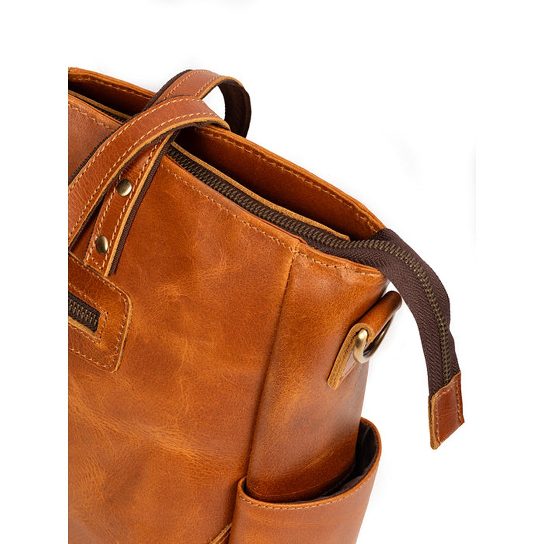 Brown leather backpack with a visible brand logo on a white background