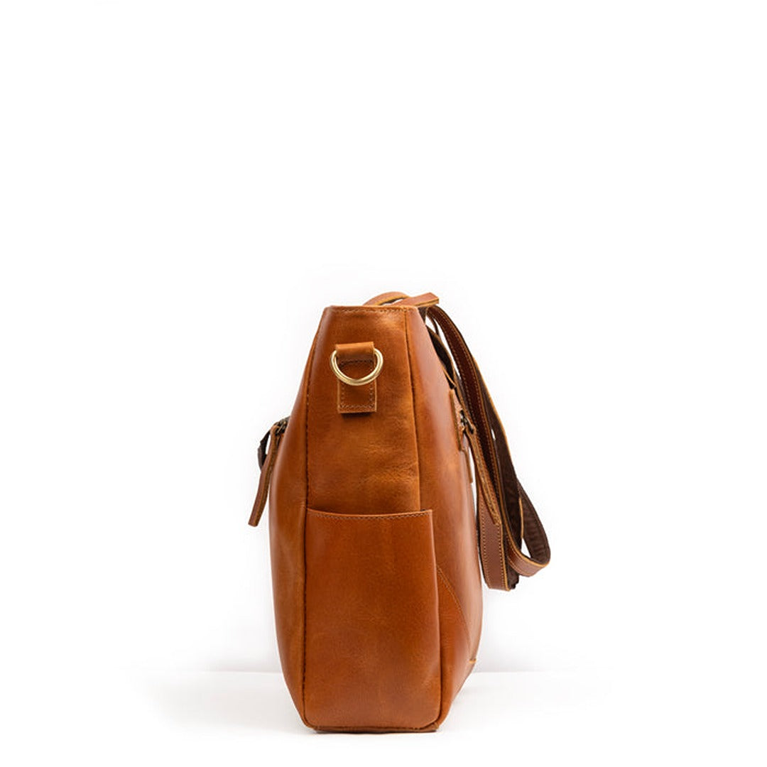 Brown leather handbag with a gold clasp on a white background