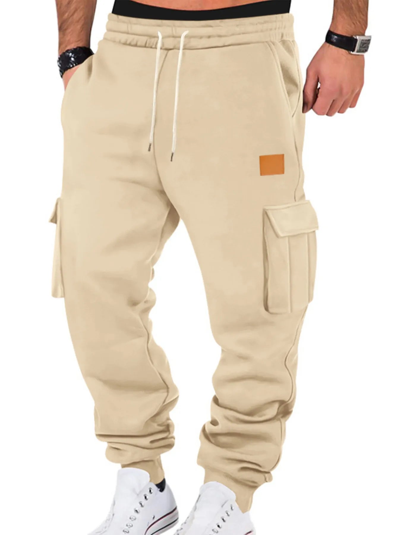 Beige cargo jogger pants worn by a person on a white background