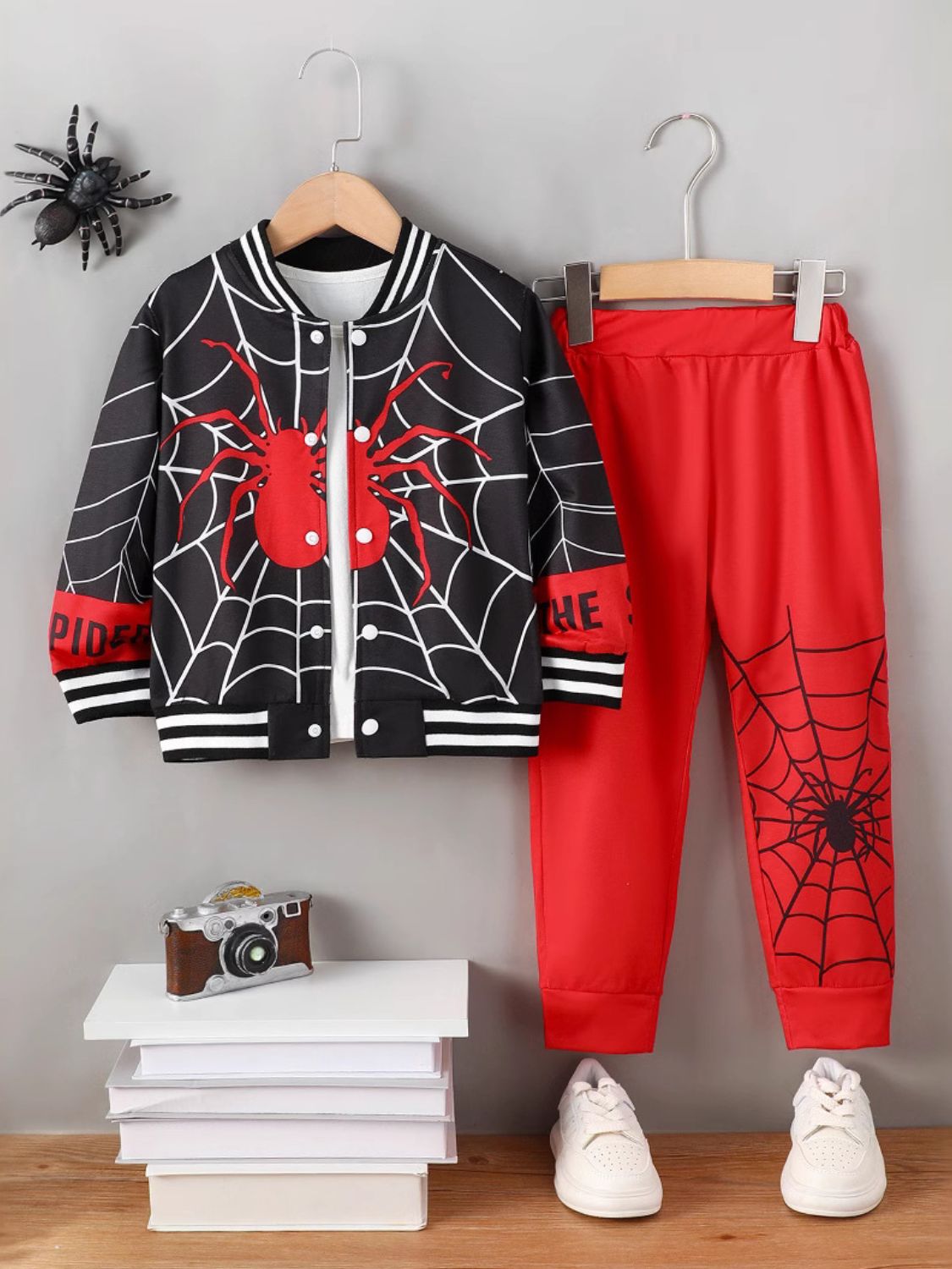 Unleash your inner spider with our Spider and spiderweb design Top and Pants Set! This stylish set includes a long sleeve button up top with baseball color, cuffs and trim, a unique spider design, paired with matching red pants with the spider in the web design. Make a statement with this fashionable and confident set.