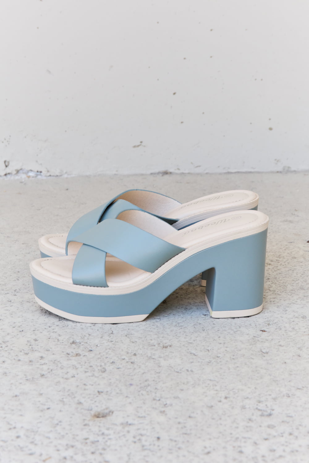 These Misty Blue platform sandals offer both style and comfort. Adjustable crisscross straps provide a secure fit, while the contrasting colors give a fresh, modern look. The platform sole adds height and stability, making them great for all-day wear. Perfect for upgrading your summer style.