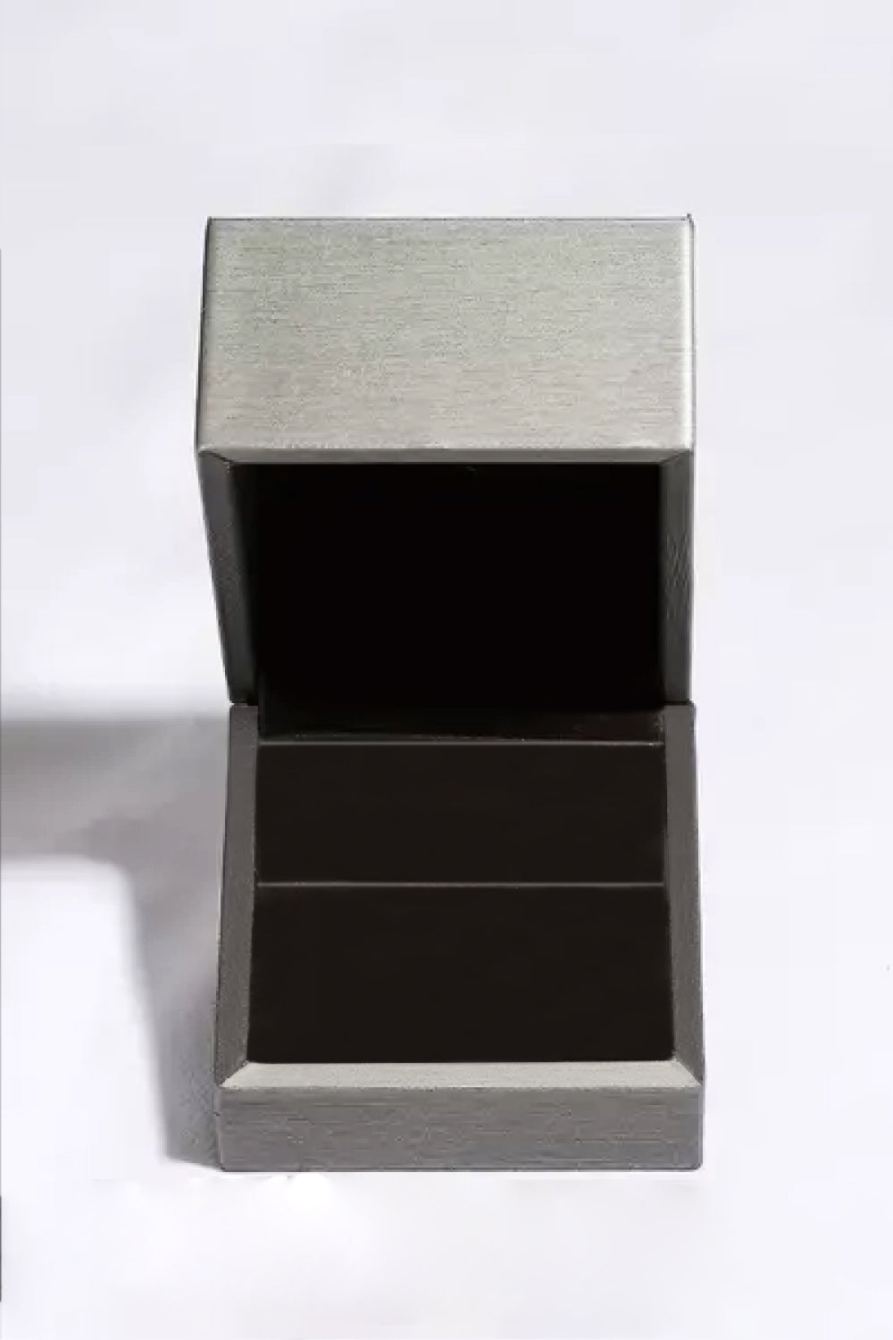 Silver jewelry box with a textured lid on a white background