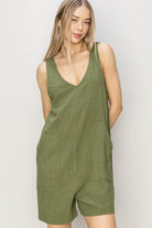 This V-Neck Cruisin Essentials Sleeveless Romper combines comfort and style with its breathable 80% rayon and 20% linen fabric. Featuring a deep V-neck and relaxed bodice, it flatters every figure while the breezy shorts keep you cool. Equipped with handy pockets, it offers practicality without compromising on fashion. Pair it with sandals and a crossbody bag for an effortlessly chic and timeless look perfect for any casual outing.