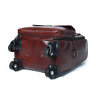Brown suitcase with wheels on a white background