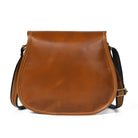Brown leather saddle bag on a white background