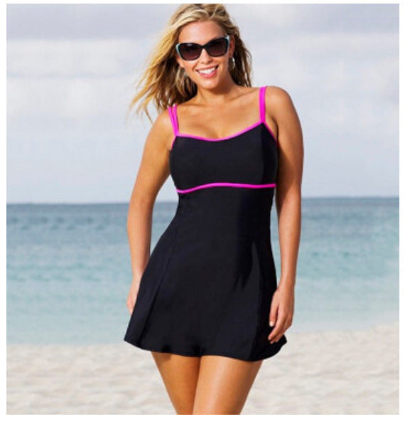 Woman wearing a black and pink swimsuit on a beach
