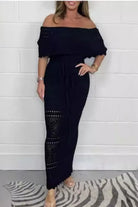 The Riviera Maxi dress showcasing the crochet off-the-shoulder neckline, detailed waist cutout, and elegant front-tie design. Black.