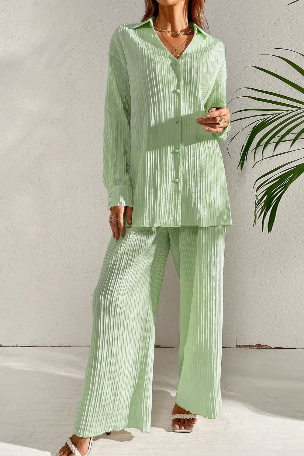 Full-length view of the Capri Collared Button-Down Pant Set in Gum Leaf Green, showcasing its relaxed long-sleeve silhouette, clean tailored collar, and fluid wide-leg pants.