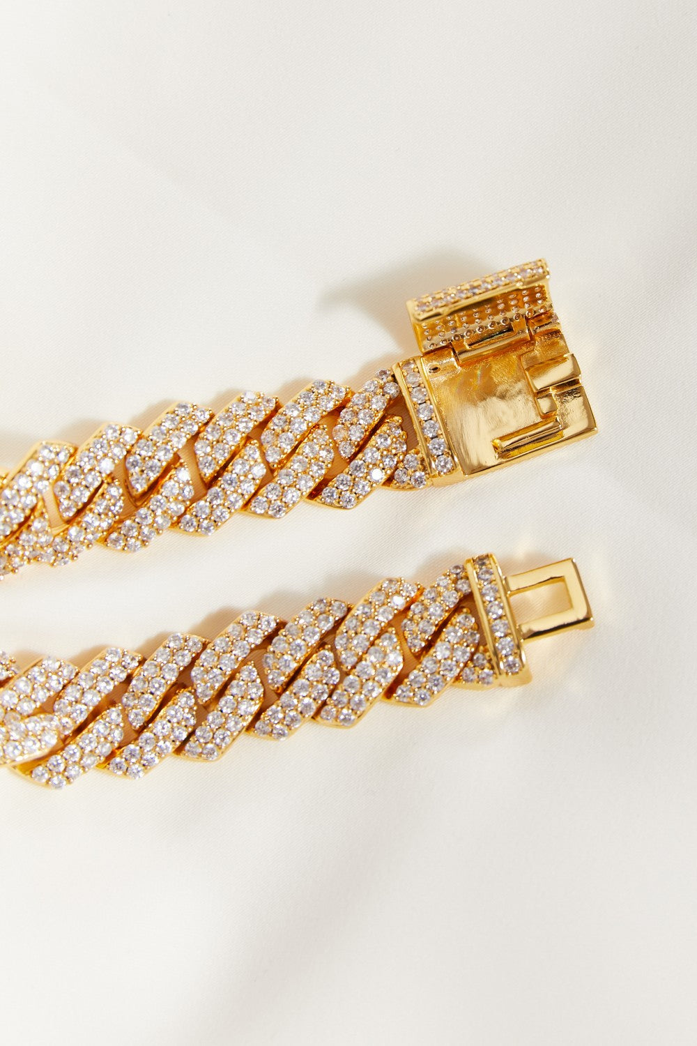 Gold bracelet with diamond accents on a light background