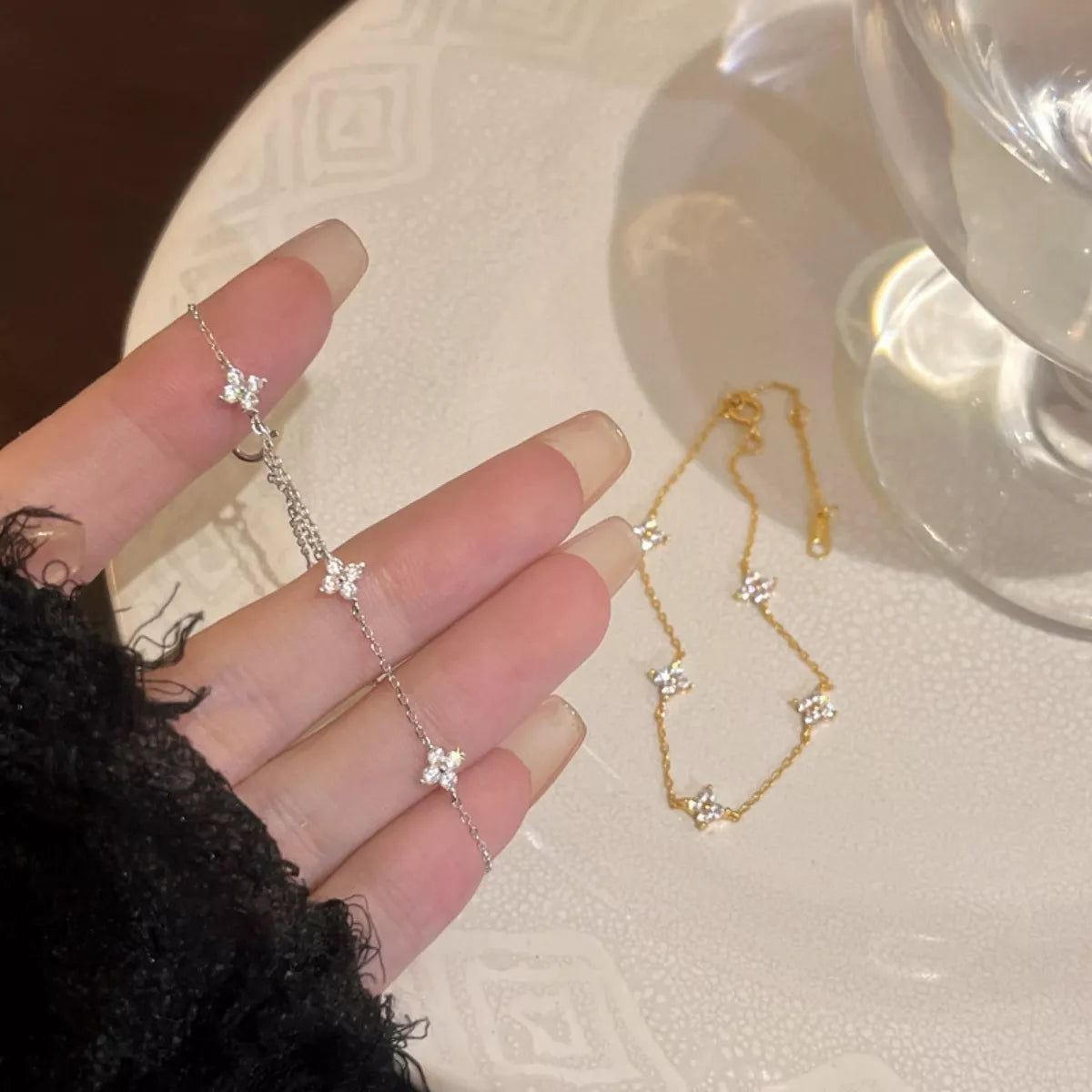 Studio view of the premium 18K gold-plated Clover Bracelet, showcasing its delicate zircon-accented charm and fine, luminous chain.