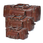 Set of three brown leather suitcases of different sizes on a white background