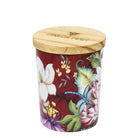 Anuschka Cedar Rose glass jar candle with floral and dragonfly artwork, white wax, and a wooden lid beside it.