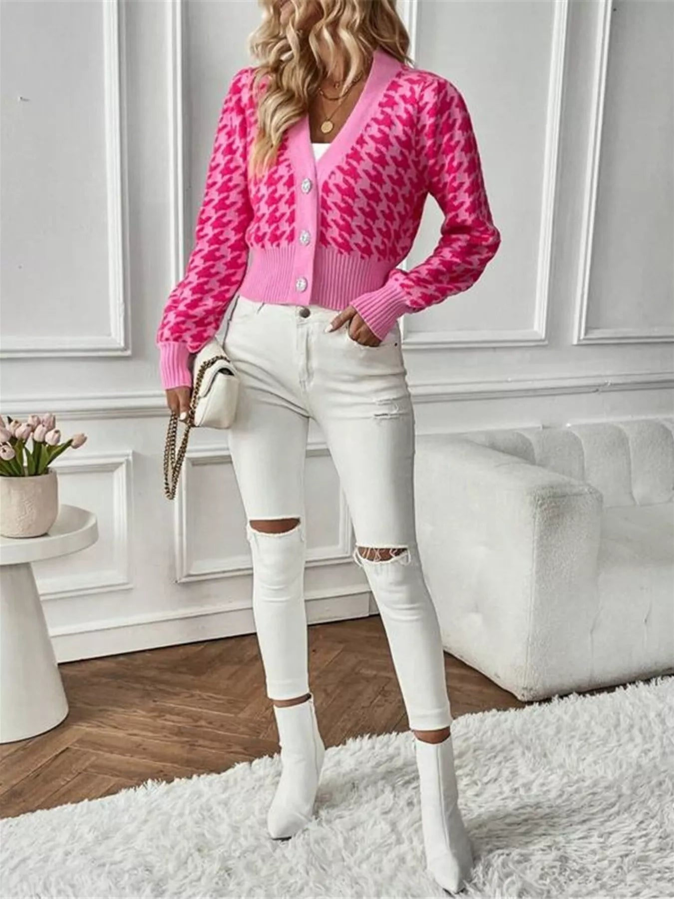 This Houndstooth V-Neck Button Up Cardigan combines a classic pattern with a tailored fit. Its V-neck design layers easily over shirts or tees, and the button-up front offers adjustable comfort. Durable and versatile, it suits both professional and casual occasions.
