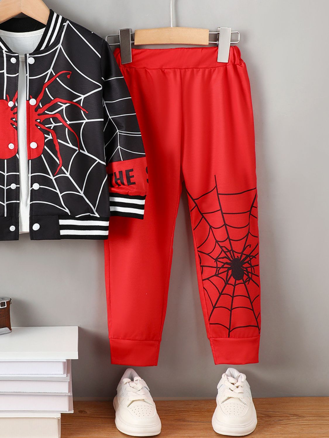 Unleash your inner spider with our stylish and confident Spider Baseball Collar Top and Pants Set! Featuring a unique spider and spiderweb design on a long sleeve button up top with baseball color, cuffs and trim, and matching red sweatpants with spider and web design. Make a bold statement with this fashionable set!