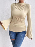 This Bell Sleeve Fitted T-Shirt combines a streamlined mock neck with elegantly flared bell sleeves for a refined silhouette. The fitted cut enhances your shape, while the unique sleeve design adds sophistication and movement. Ideal for layering or wearing solo, it offers both comfort and contemporary style suitable for various occasions.