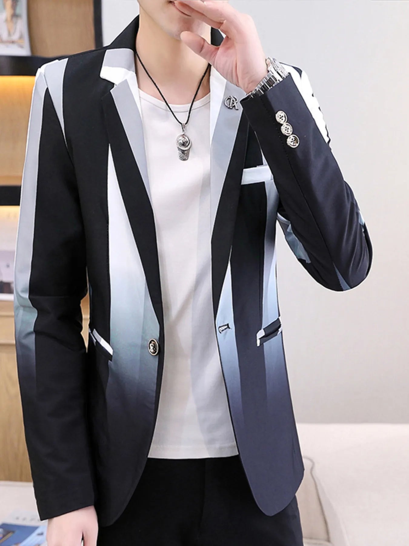 Person wearing a stylish black and white striped blazer over a white shirt.