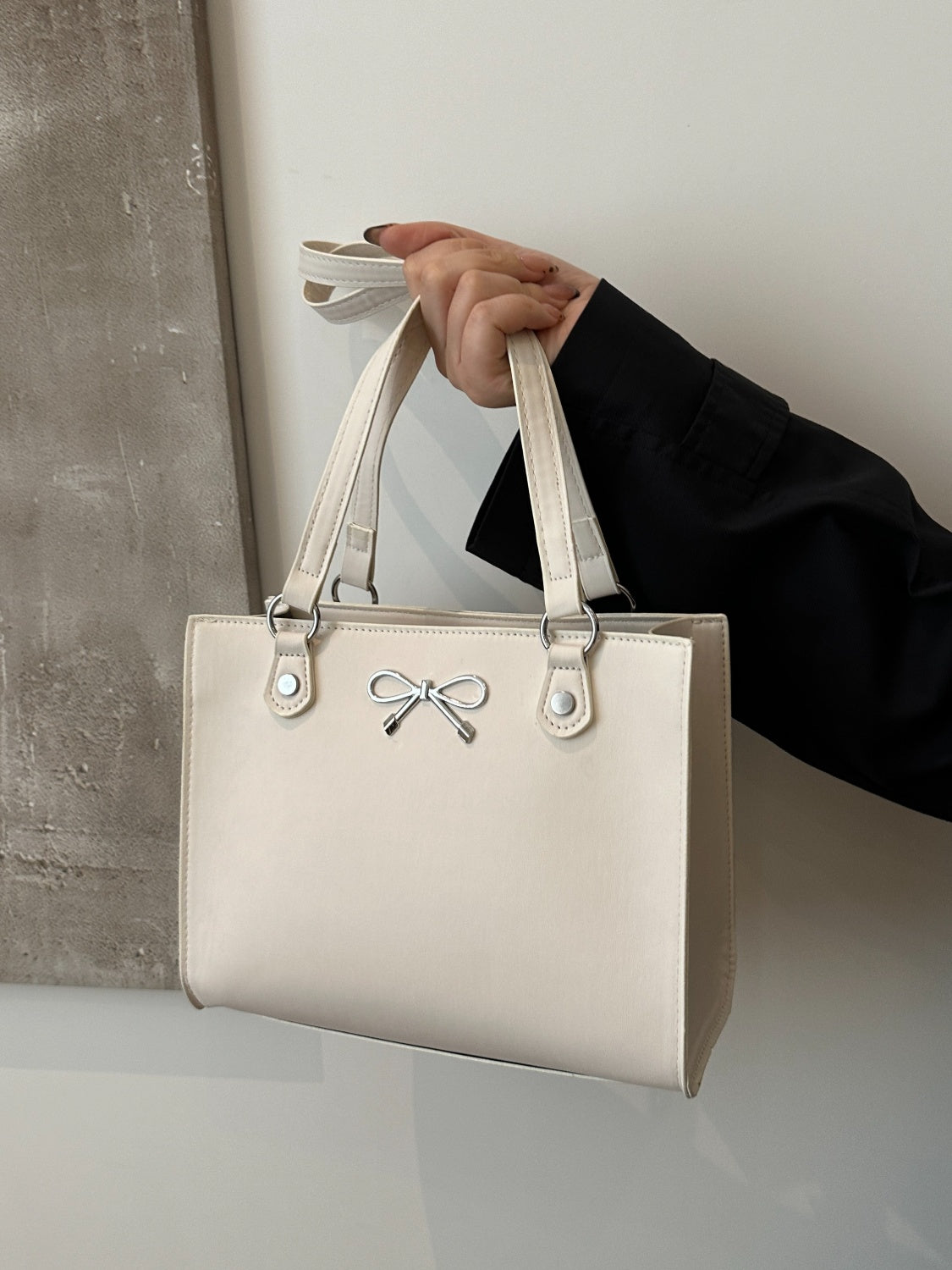 Elevate your style game with our Bow faux leather shoulder bag. Crafted from high-quality leather, this sleek and stylish bag offers both durability and a luxurious feel. Perfect for any outfit, it adds a touch of sophistication to your look. Upgrade your accessories with our timeless and elegant design.