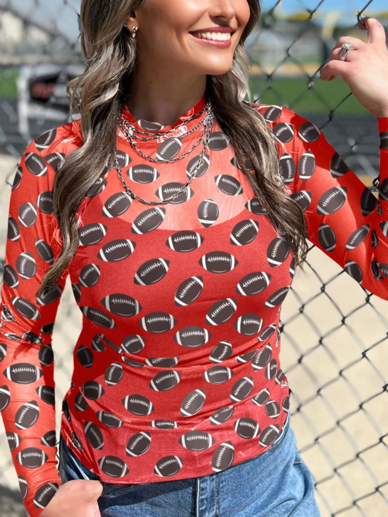 This Game Day Mesh Sheer Long Sleeve Top combines breathable mesh fabric with a streamlined design to keep you comfortable and stylish. Its lightweight, sheer material enhances airflow, while the long sleeves offer versatility for layering or wearing solo. Perfect for fans who want a modern, sporty look with expert craftsmanship and attention to detail.