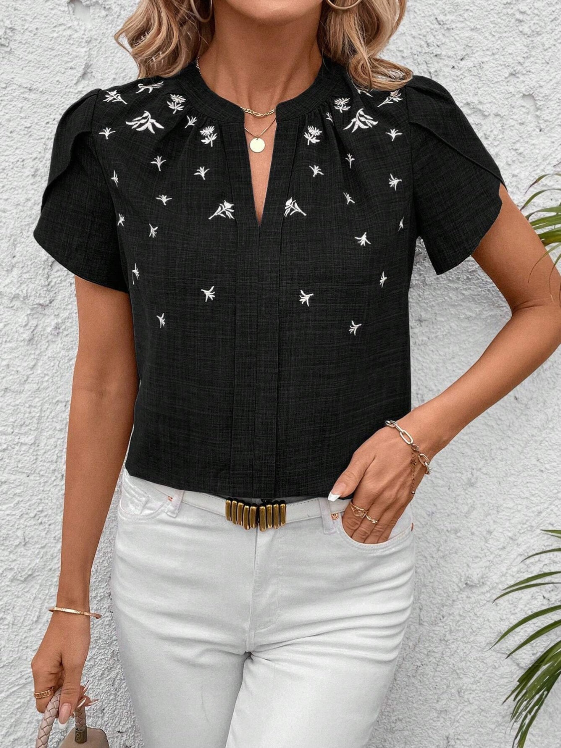 This Floral Notched Short Sleeve Blouse features a clean notched neckline and a delicate floral print. Made from breathable fabric, it ensures comfort all day and is perfect for both work and casual wear.