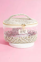 Cosmetic bag with floral design and 'Wild Fig' branding on a pink background