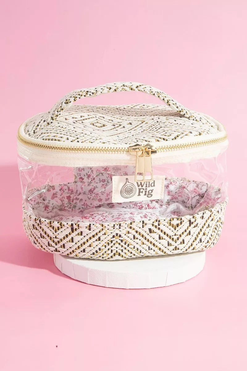 Cosmetic bag with floral design and 'Wild Fig' branding on a pink background