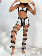 Woman wearing a black and white crochet outfit on a white background