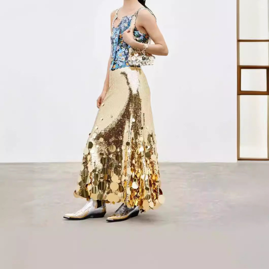 Woman wearing a gold sequin dress with a floral top in an indoor setting