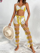 Woman wearing a yellow and white crochet two-piece swimsuit holding a hat on a light background