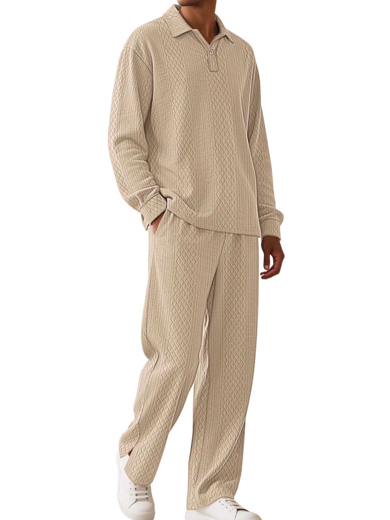A man wearing a matching beige textured two-piece lounge set consisting of a long-sleeve polo shirt and wide-leg pants, paired with white sneakers, against a plain white background.