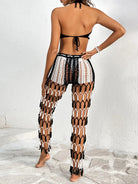 Person wearing a black and white fishnet outfit against a white background
