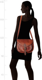 Woman wearing a brown leather crossbody bag on a white background