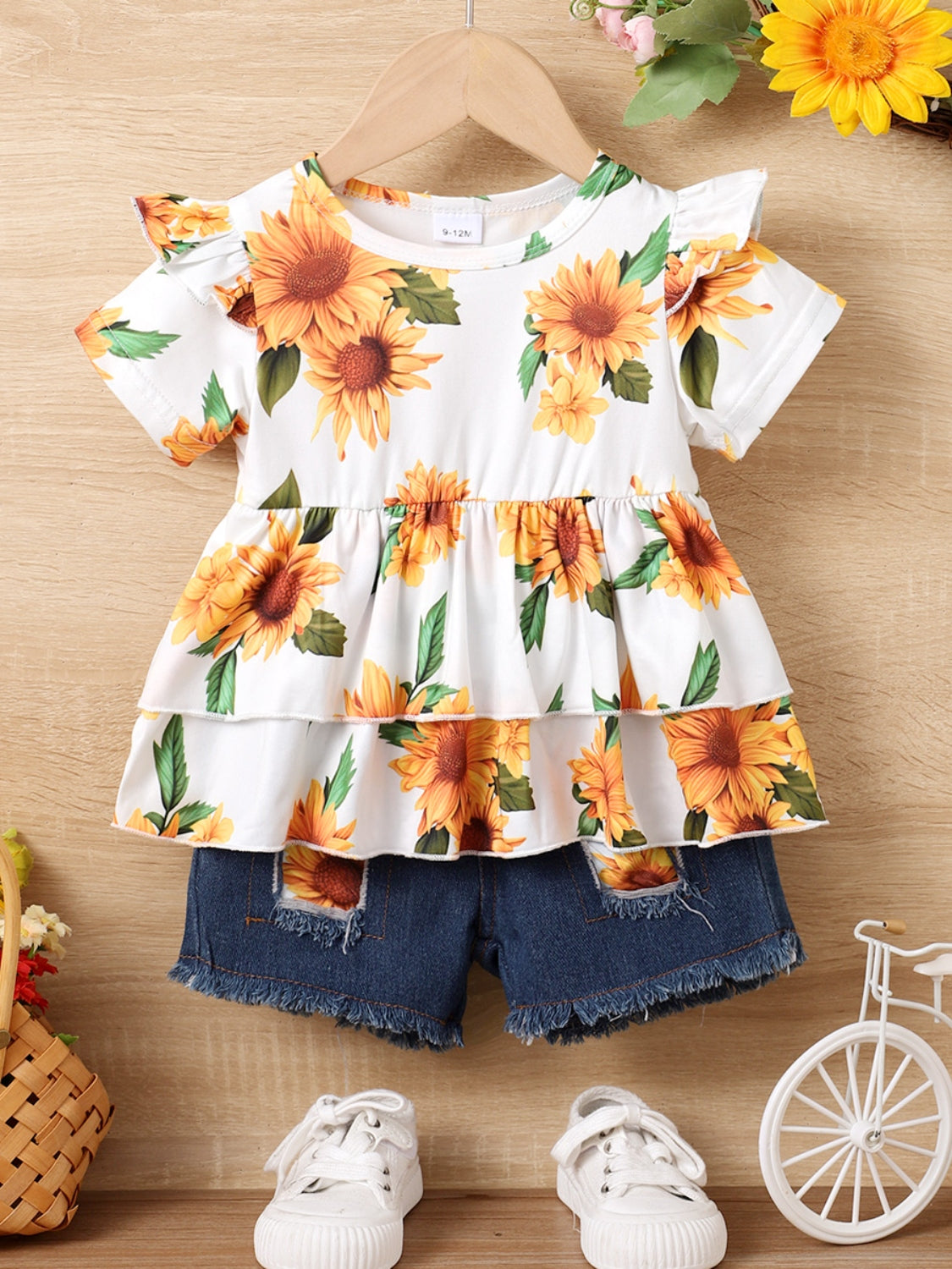 Get your little one ready for sunny days with our Children's Sunflower Ruffled Short Sleeve Top and Shorts Set! Featuring a cute ruffled design and cheerful sunflower print, this outfit is perfect for warm weather. Your child will be both stylish and comfortable in this charming ensemble!