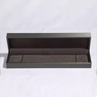 Open gray jewelry box on a white background