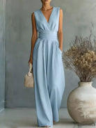 Front studio view of a model wearing the premium Savannah Wide-Leg Knit Jumpsuit, showcasing its relaxed, fluid silhouette and elegant high-quality knit texture.