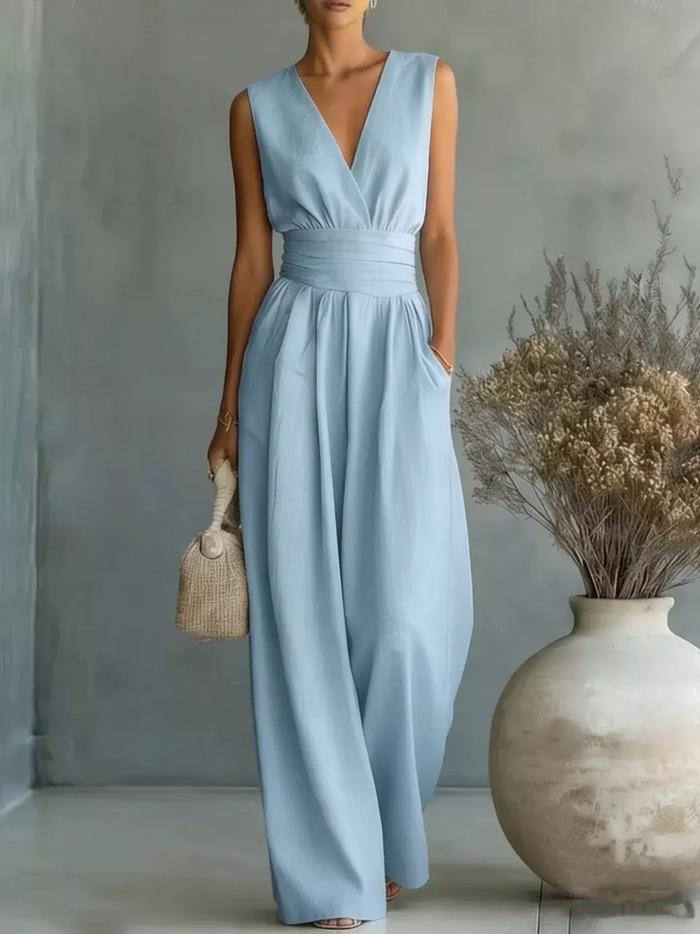 Front studio view of a model wearing the premium Savannah Wide-Leg Knit Jumpsuit, showcasing its relaxed, fluid silhouette and elegant high-quality knit texture.
