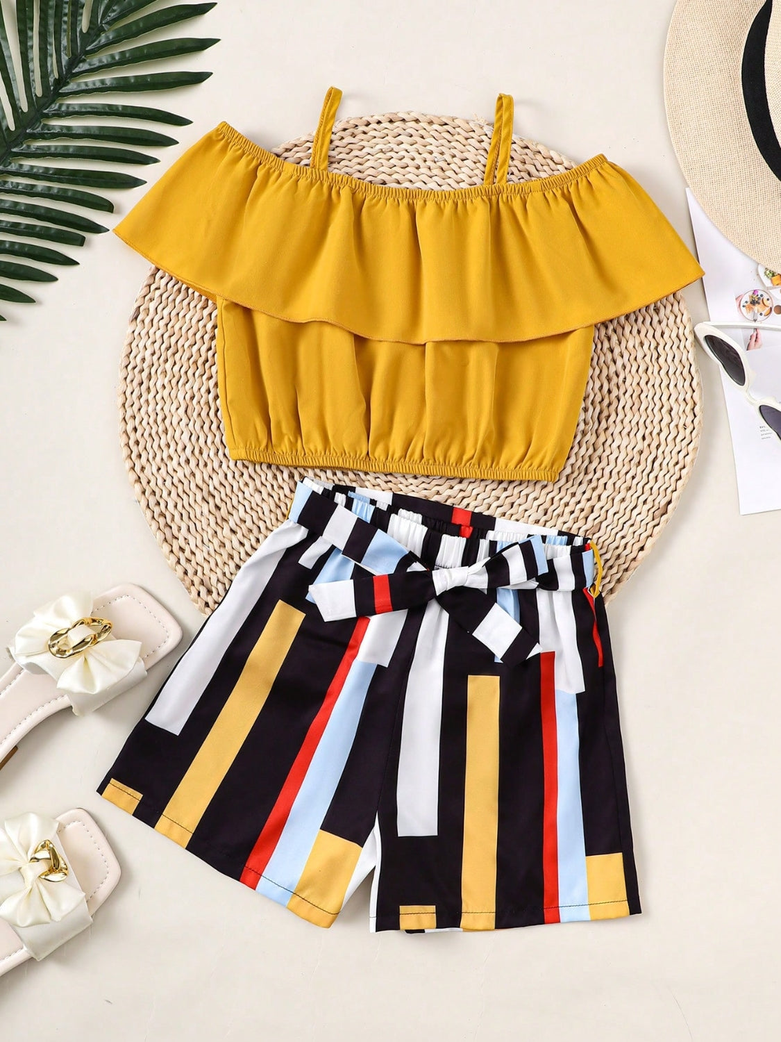 Get your little one ready for summer in our adorable Children's Ruffled Spaghetti Strap Top and Pants Set! With cute ruffles and a comfortable fit, this set is perfect for playtime, outings, and more. Made with high-quality materials for long-lasting wear. Your child will love the stylish and fun look, and you'll love the durability and convenience.