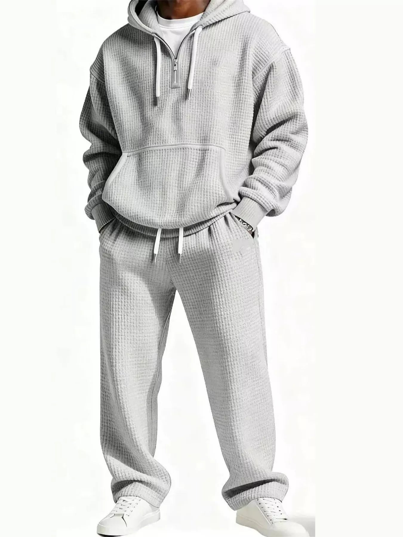 Light gray men's oversized waffle knit track set with hoodie pocket and elastic waist pants.