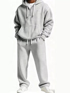 Light gray men's oversized waffle knit track set with hoodie pocket and elastic waist pants.