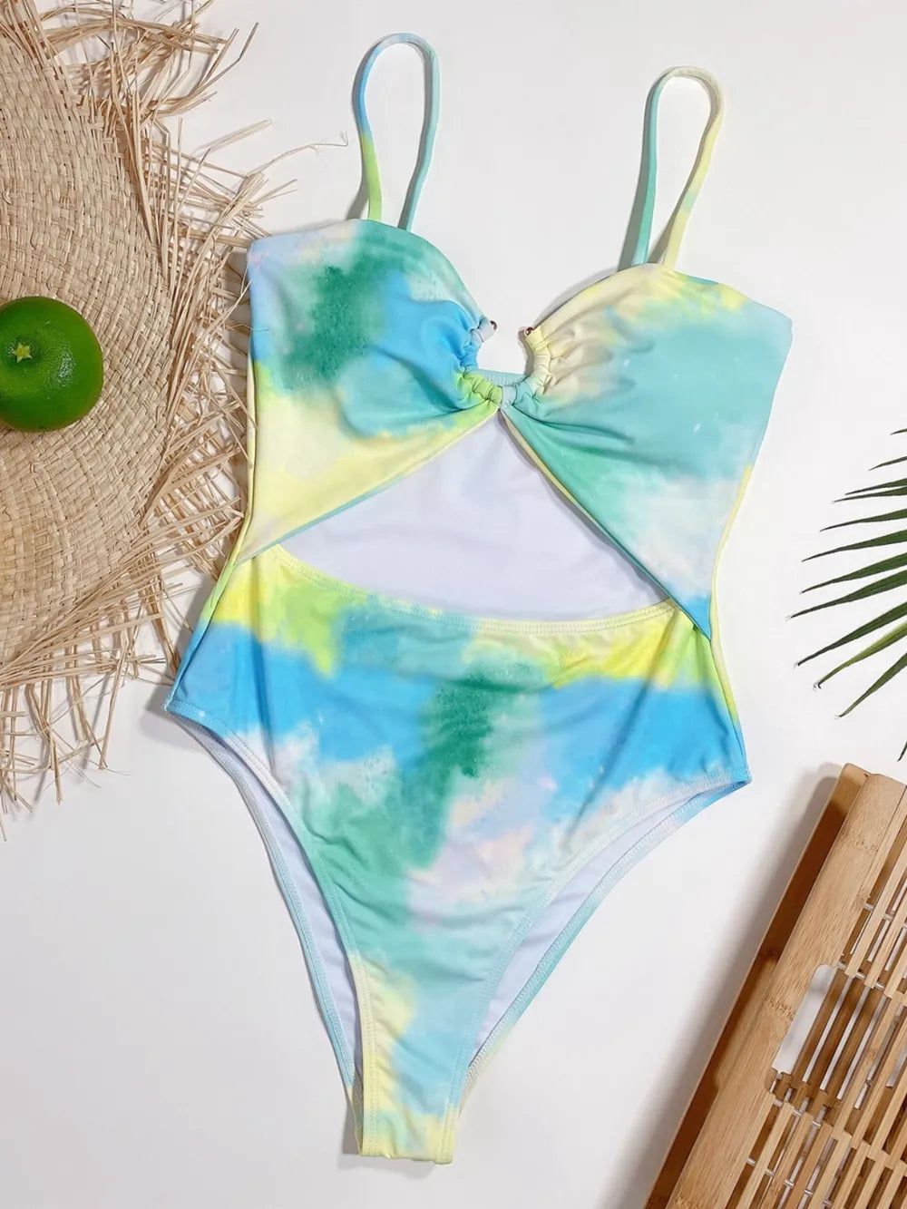 Tie-dye swimsuit on a white background with natural elements.