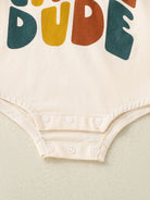 Baby onesie with colorful text on a light background